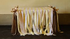 bronze furniture draped in pastel ribbons