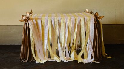 bronze furniture draped in pastel ribbons