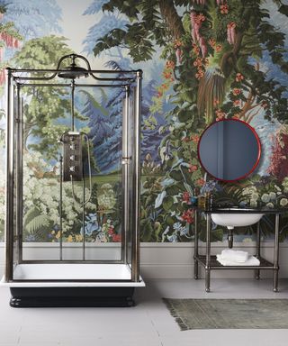 An example of master bathroom ideas showing a bathroom with a large landscape mural, black metal shower cubicle and a vanity