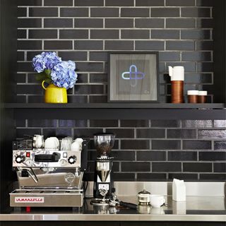 kitchen with black subway tiles and coffeemaker