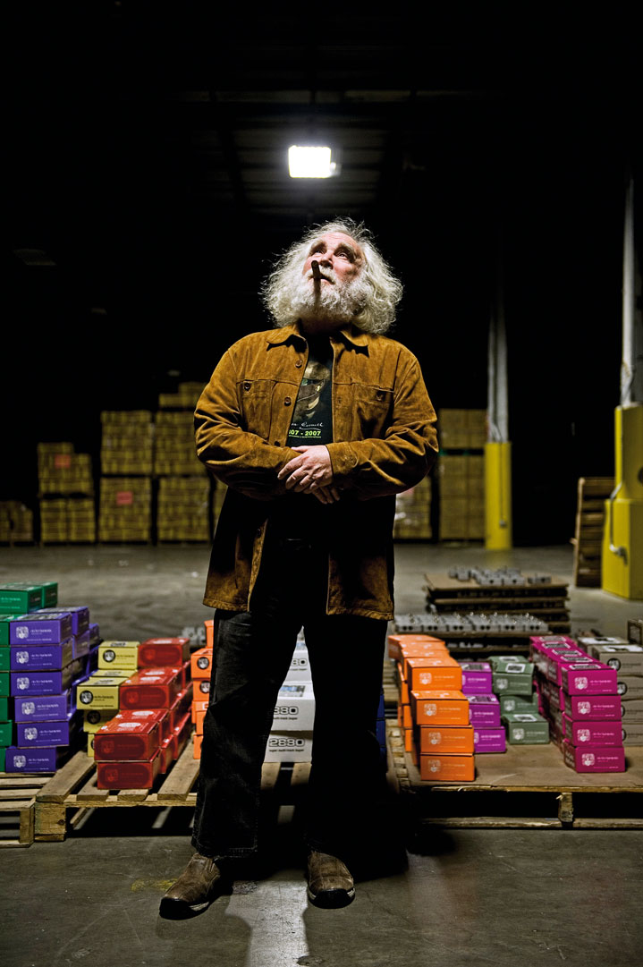 Mike Mathews, gazing upwards, in the Electro-Harmonix warehouse, surrounded by pedals in 2013