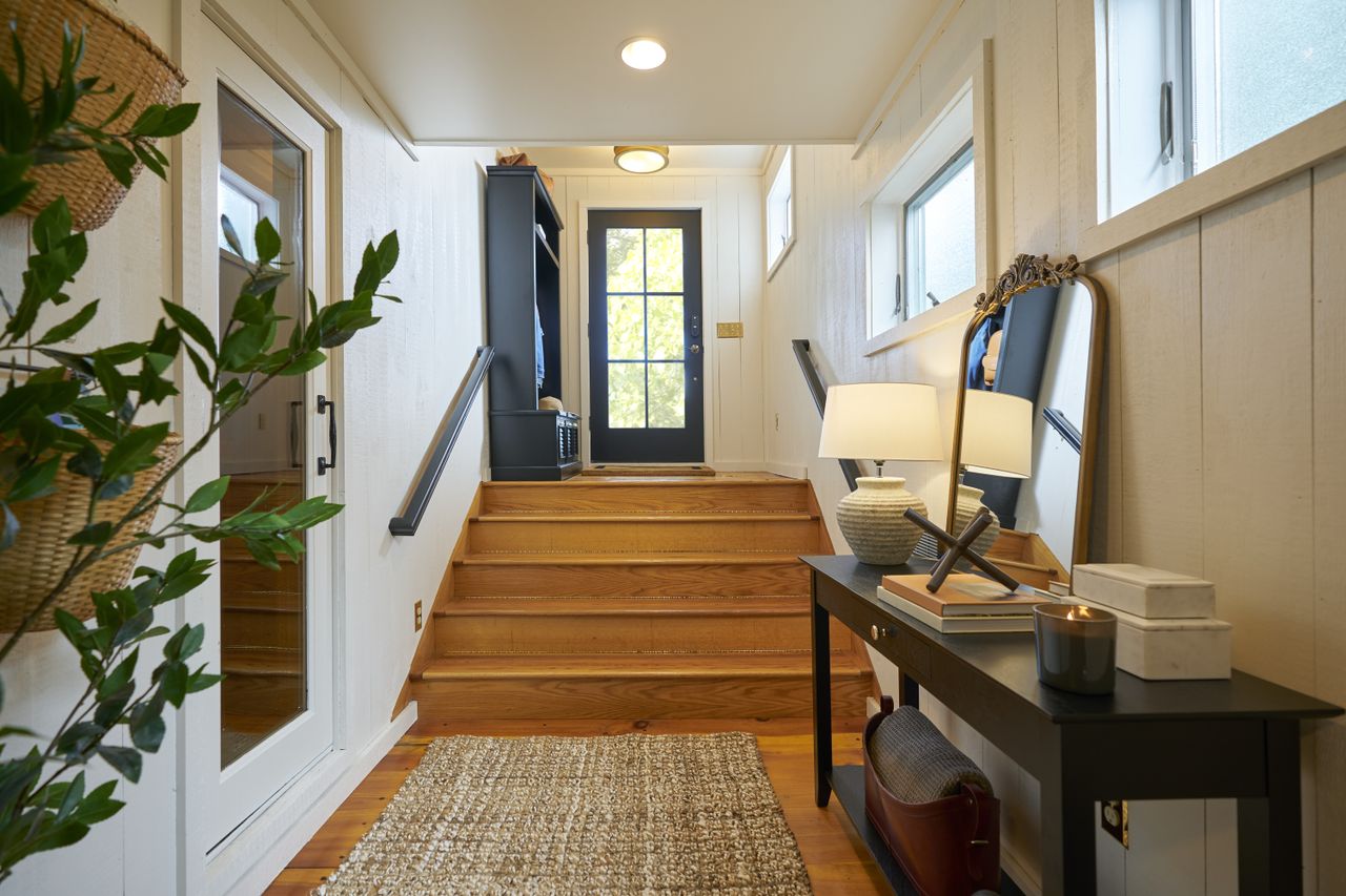 An entryway with wooden stairs