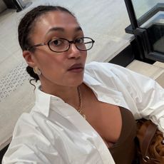 A woman wearing black glasses