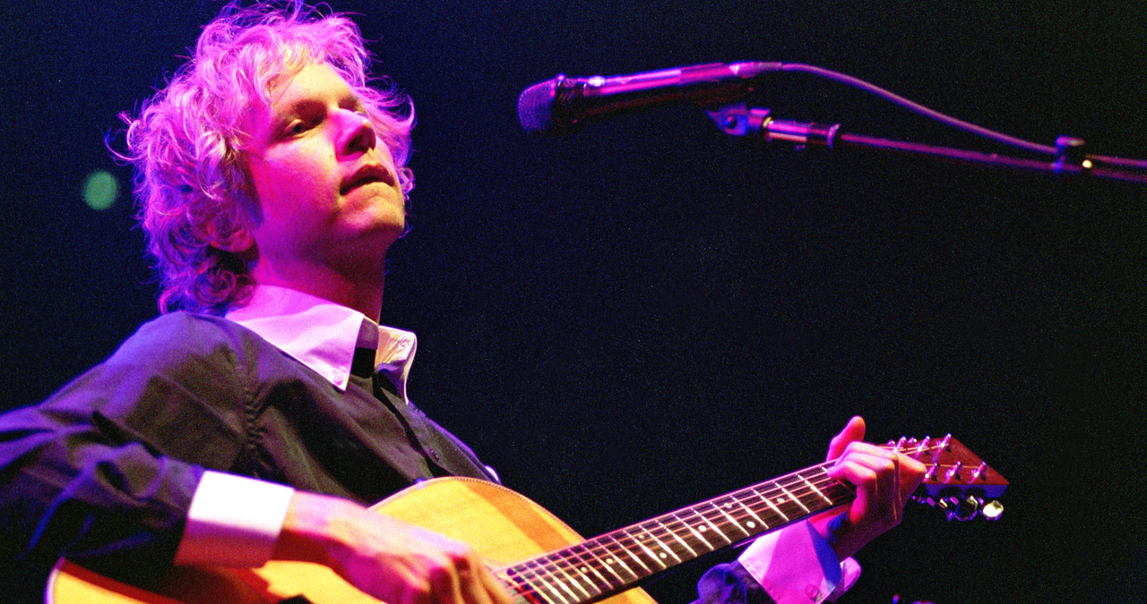 Beck plays acoustic guitar