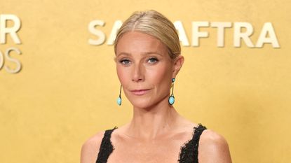 Gwyneth Paltrow is pictured with her hair in a low-bun style, and wearing a black dress and pink-nude, sparkly lip gloss at the 32nd Annual Actor Awards at Shrine Auditorium and Expo Hall on March 01, 2026 in Los Angeles, California. 