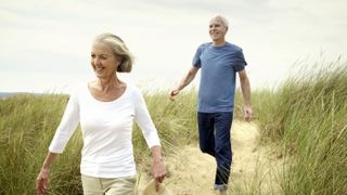 Senior couple walking at beach