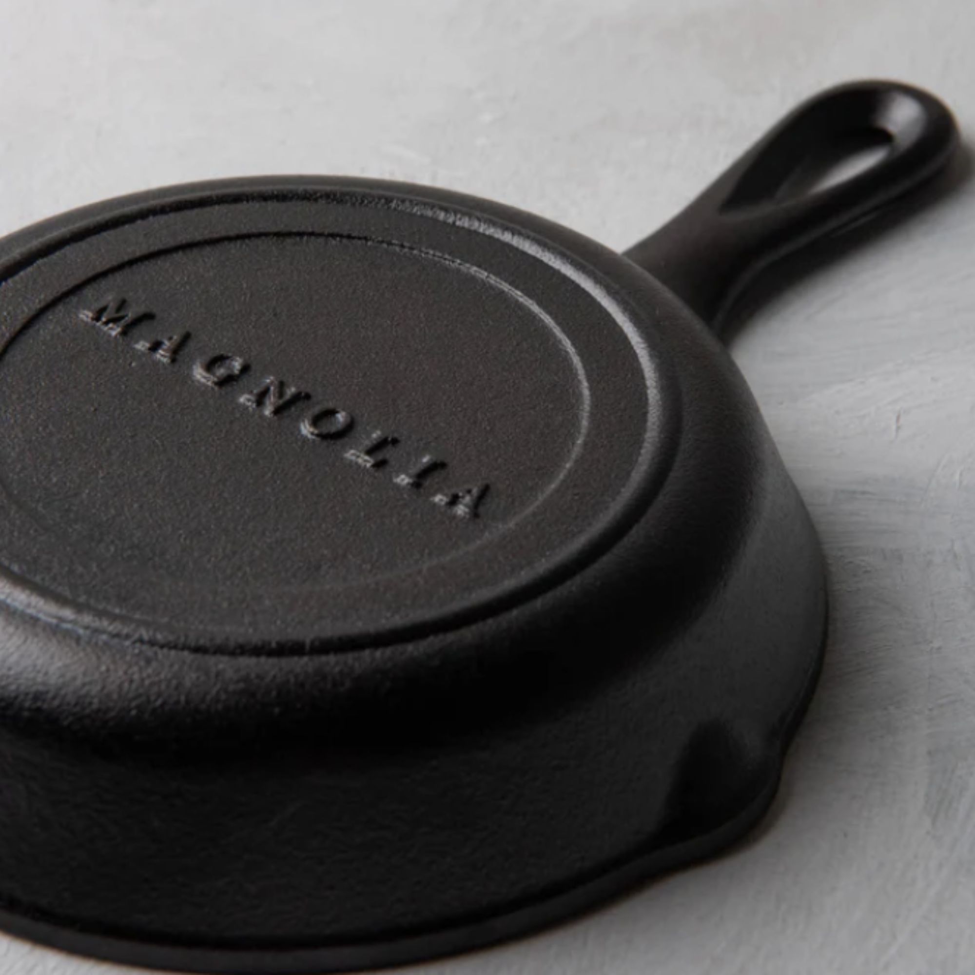 Small cast iron skillet with Magnolia branding on the base