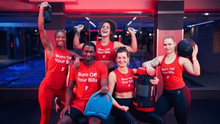 Fitness First trainers holding gym equipment and wearing Burn Off Your Bills T-shirts