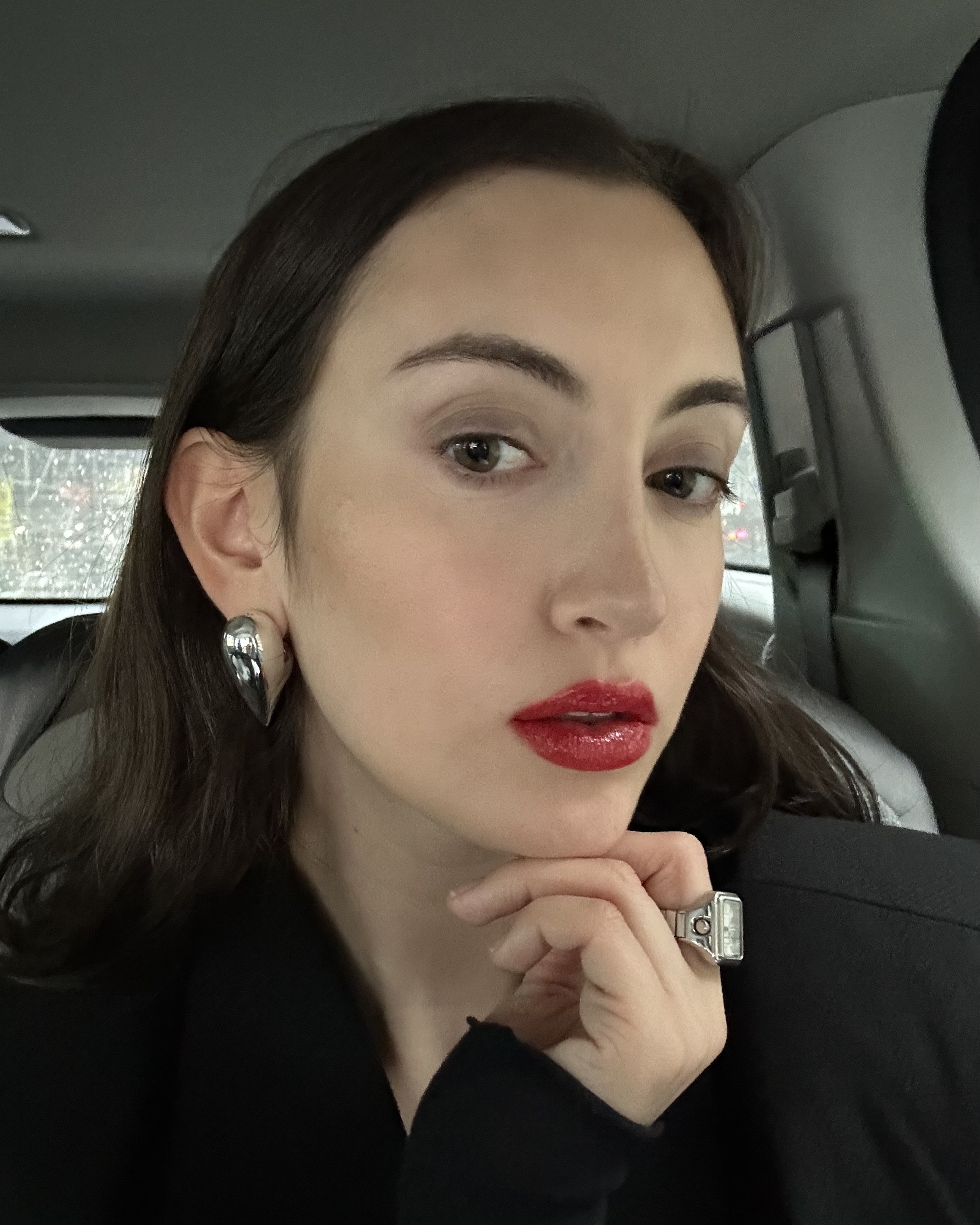 Alyssa Brascia wearing the Valentino Puffer Complex Lip Plumper Gloss over red lipstick.