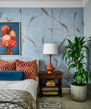 Baby blue bedroom with pop of Prussian blue in artwork and on bolster pillow