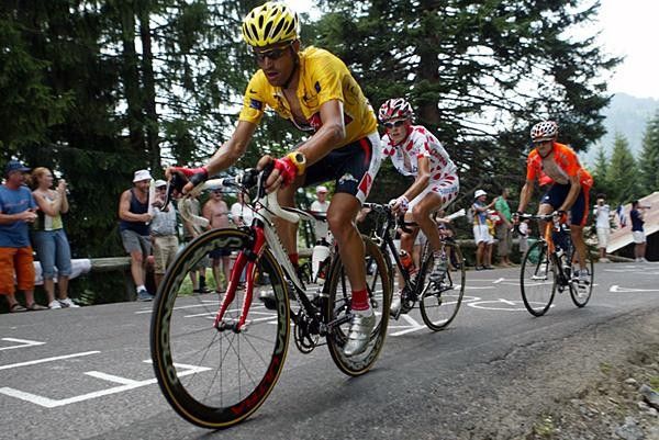 Oscar Pereiro (Illes Balears) comes past with mountain leader Mickael Rasmussen close on his wheel.