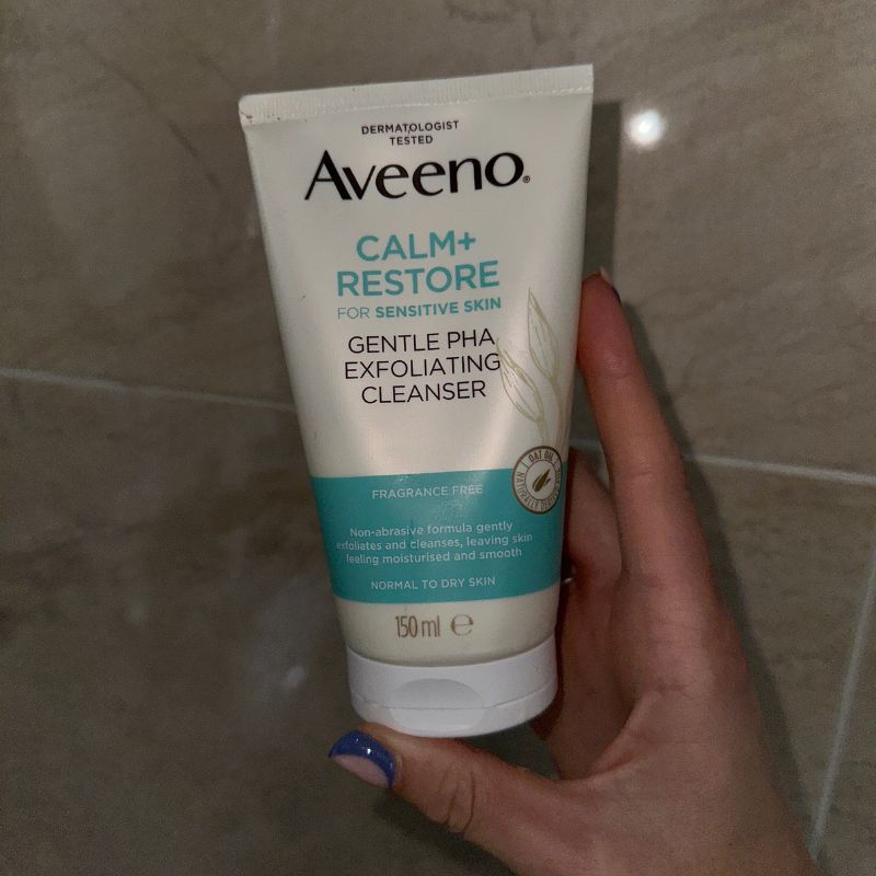 A photo of the Aveeno Face Calm + Restore gentle PHA Exfoliating Cleanser