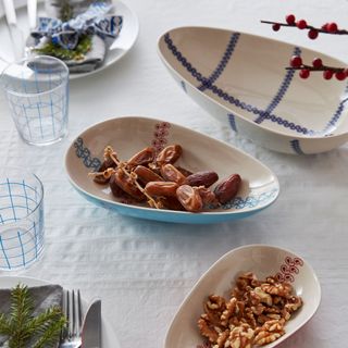 bowls with nuts and dates with glasses