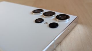 A white-backed Samsung Galaxy S23 Ultra sitting on a desk