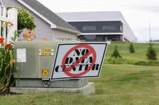  A "No Data Center" yard sign is displayed in front of a house in opposition to a proposed 300-megawatt data center at Great Stream Commons industrial park. 