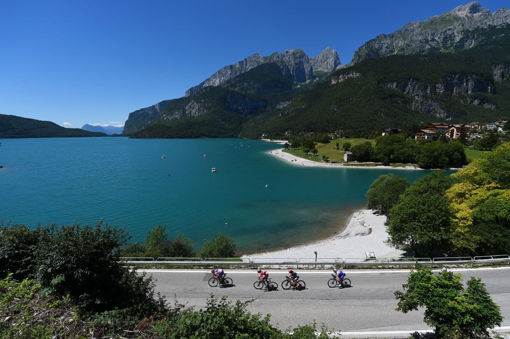 SAN LORENZO DORSINO ITALY JULY 09 Annemiek Van Vleuten of Netherlands and Movistar Team Pink Leader Jersey and general view of the peloton passing through lake Molveno during the 33rd Giro dItalia Donne 2022 Stage 9 a 1128km stage from San Michele AllAdige to San Lorenzo Dorsino 727m GiroDonne UCIWWT on July 09 2022 in San Lorenzo Dorsino Italy Photo by Dario BelingheriGetty Images
