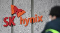 A man walks past a logo of SK hynix