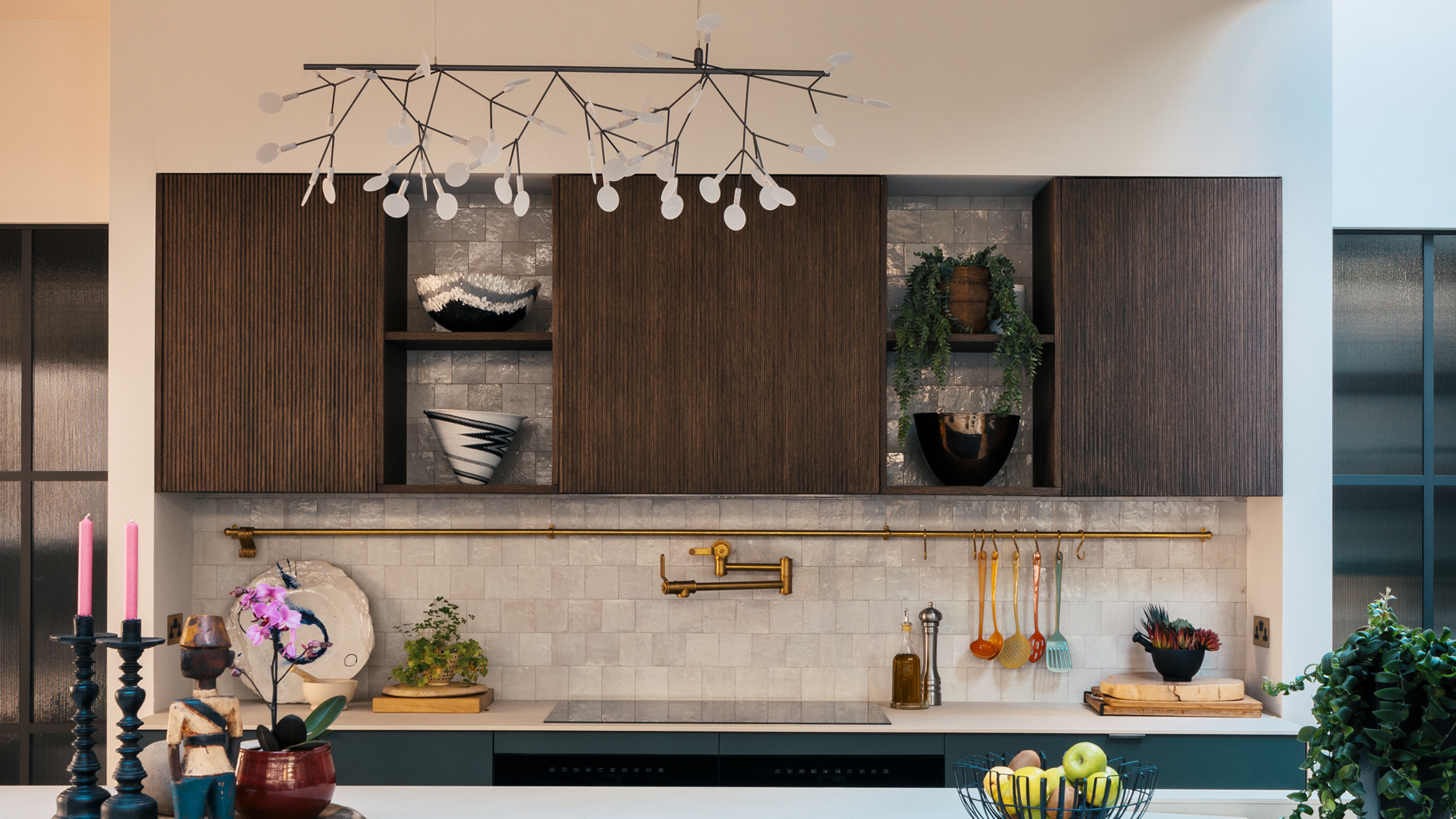 a zellige tiled splashback in a modern kitchen with wooden overhead cabinets 