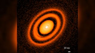 This false-colored image, captured by the Atacama Large Millimeter/submillimeter Array, shows rings around a young star named HD163296 (not the sun). 