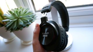Focusrite Scarlett 2i2 Studio bundle headphones being held up to the light