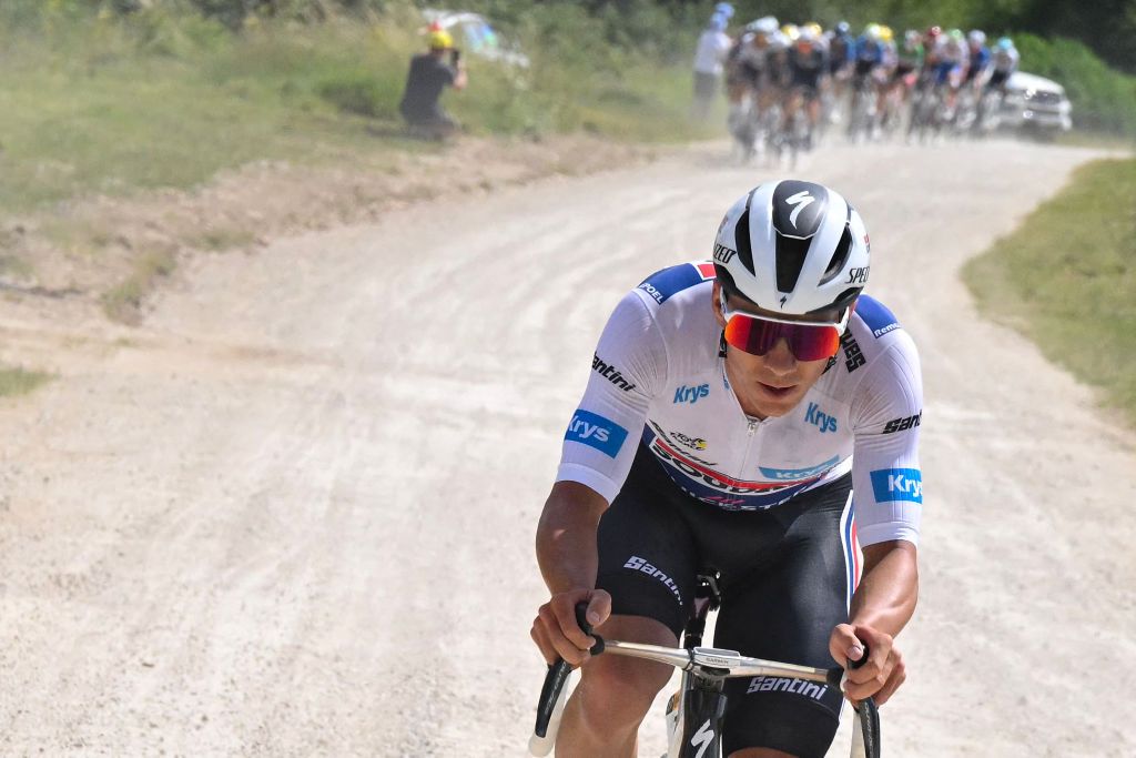 Soudal Quick-Step team&#039;s Belgian rider Remco Evenepoel wearing the best young rider&#039;s white jersey cycles over a &quot;Chemin Blanc&quot; (white road) gravel sector during the 9th stage of the 111th edition of the Tour de France cycling race, 199km stage departing and finishing in Troyes, on July 7, 2024. (Photo by Bernard PAPON / POOL / AFP)