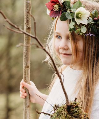small girl with wreath of flowers in hair