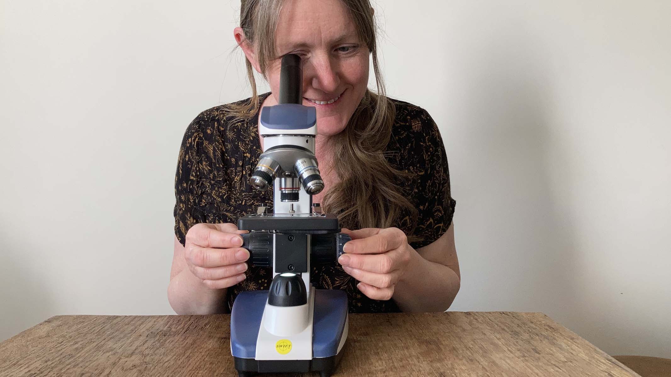 woman using a microscope