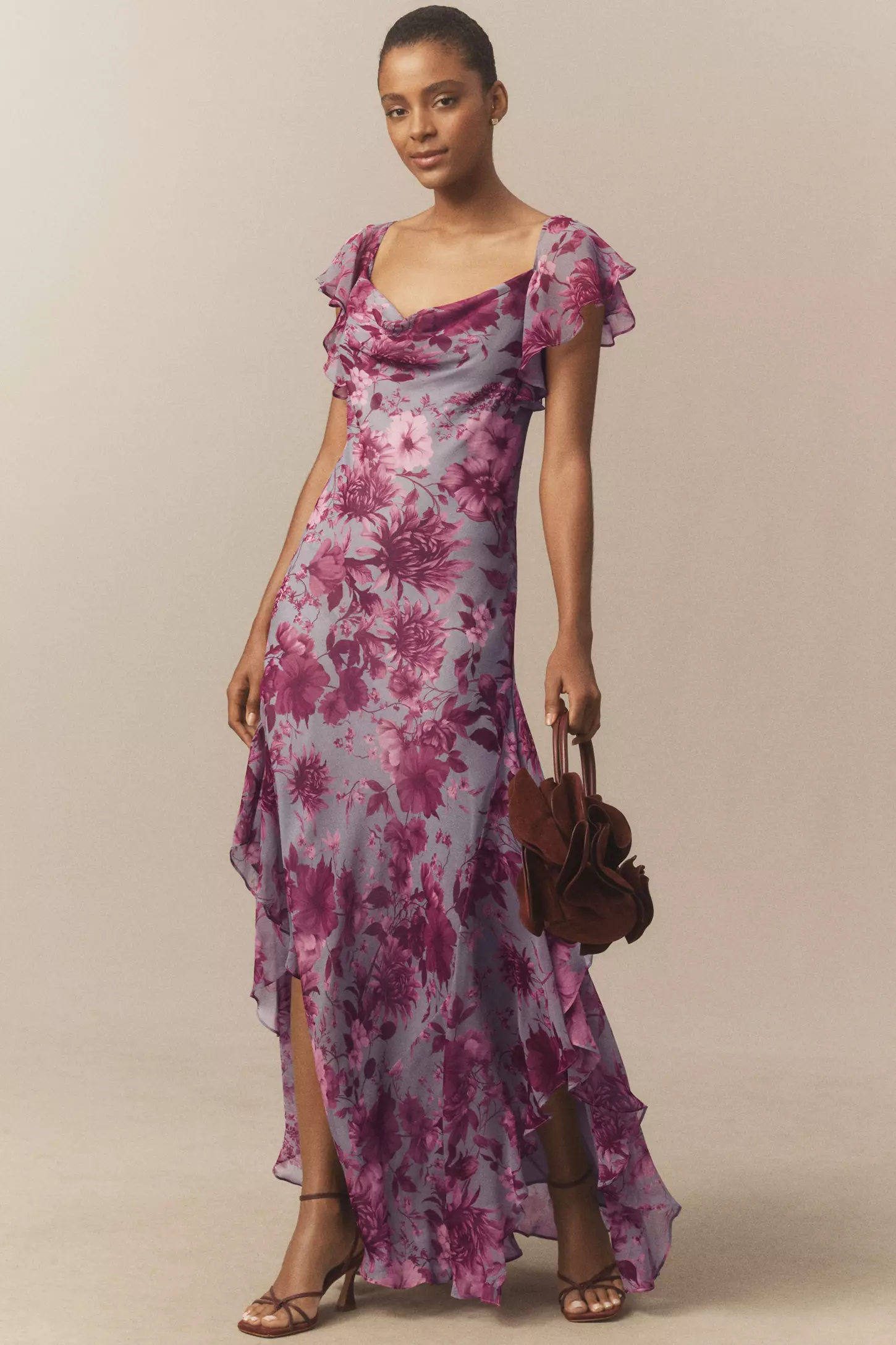 A model wearing a purple floral gown