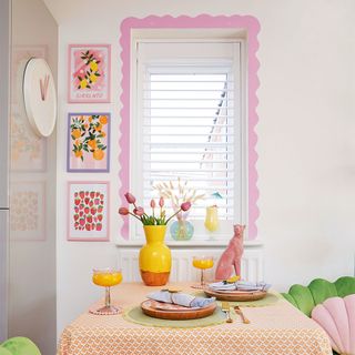 dining area with table and chairs and pink painted window trim