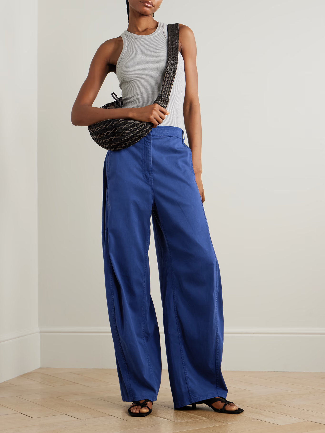 A model wearing cobalt Tibi trousers.