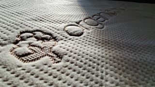 Closeup of the Saatva Foam Mattress Topper's organic cotton cover