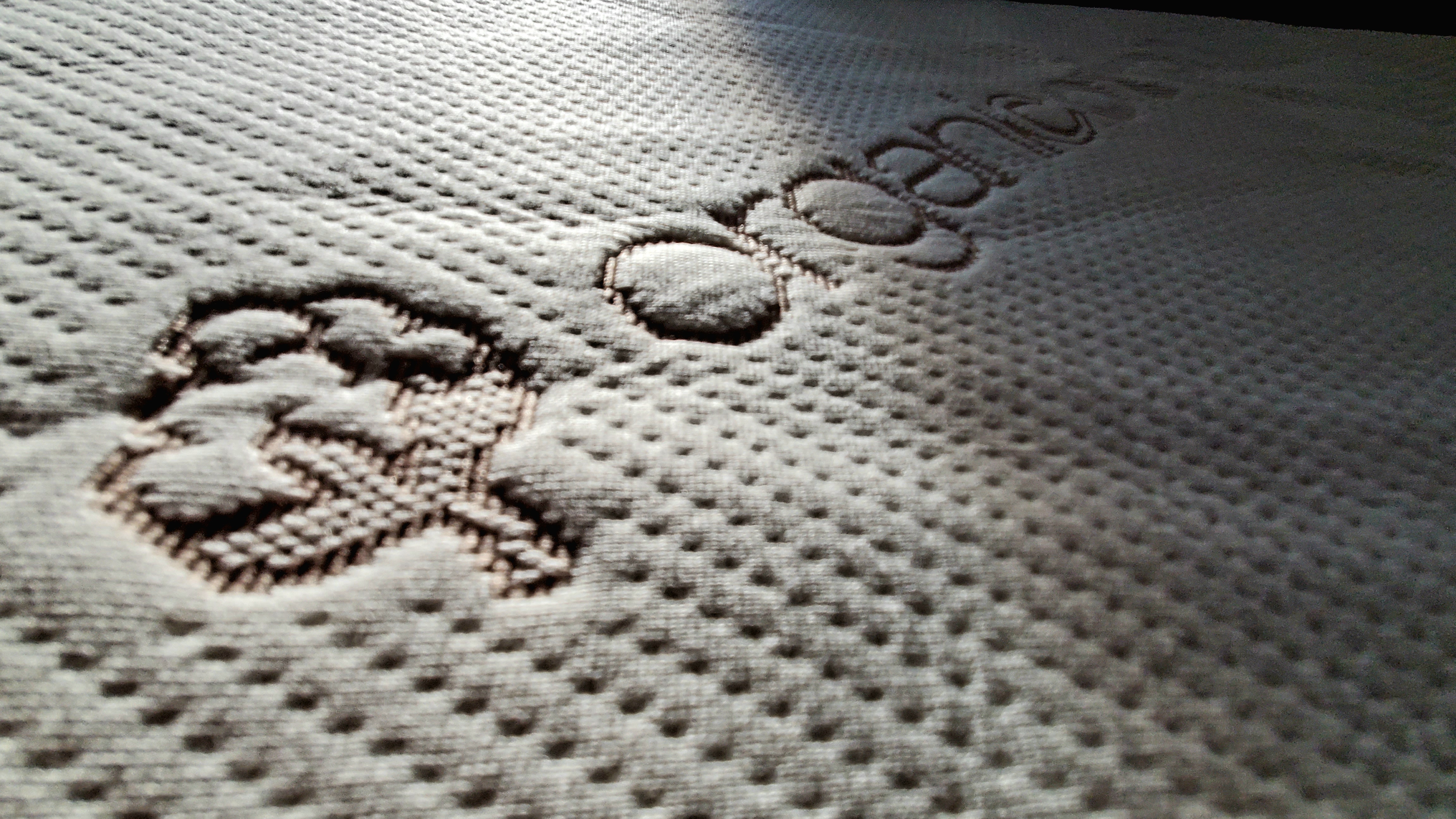 Close up of the organic cotton Saatva Foam Mattress Topper