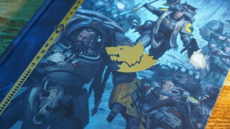 The cover of a Space Wolves Codex on a wooden surface