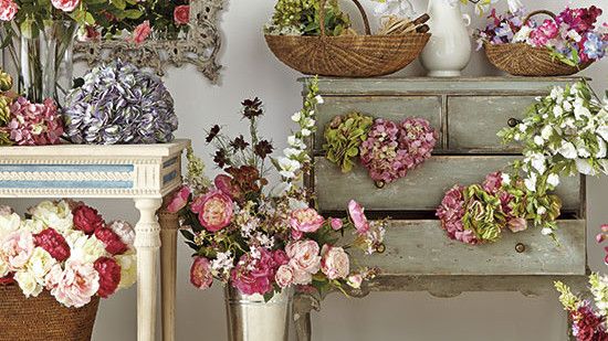 room with white wall and artificial flower pots