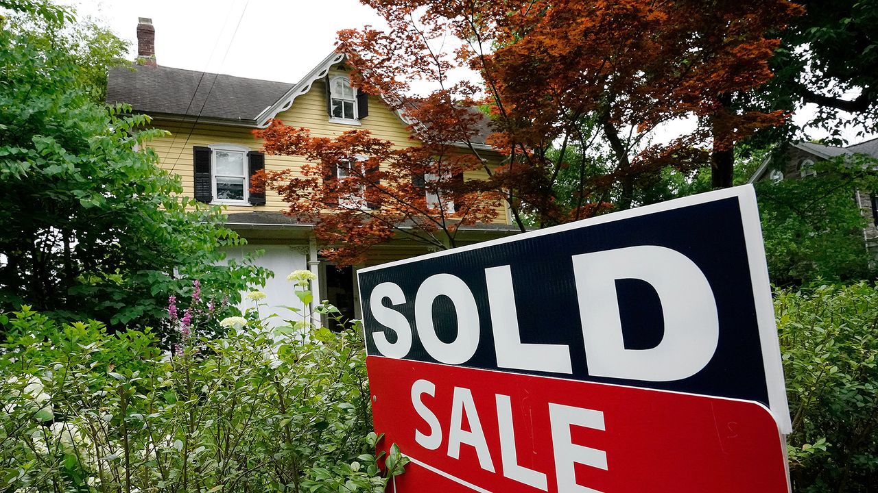 A sale sign stands outside a home in Wyndmoor, Pa