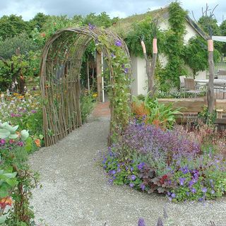 garden with gravel pathway and flowering plants