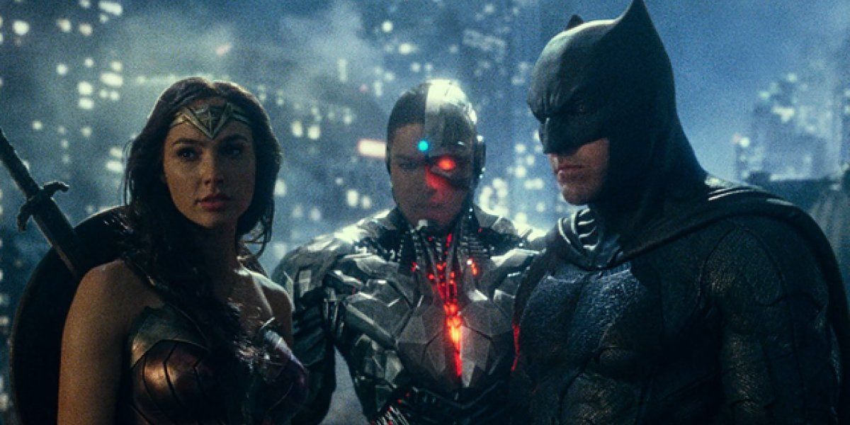 Justice League Wonder Woman, Cyborg, and Batman standing together on a rooftop