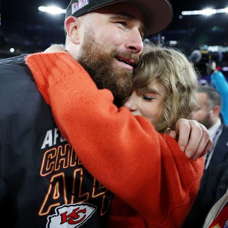 Taylor Swift and Travis Kelce on field after the Chiefs victory on January 28, 2024