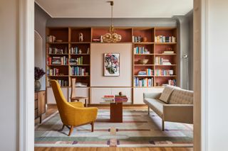 A living room with orange toned shelves