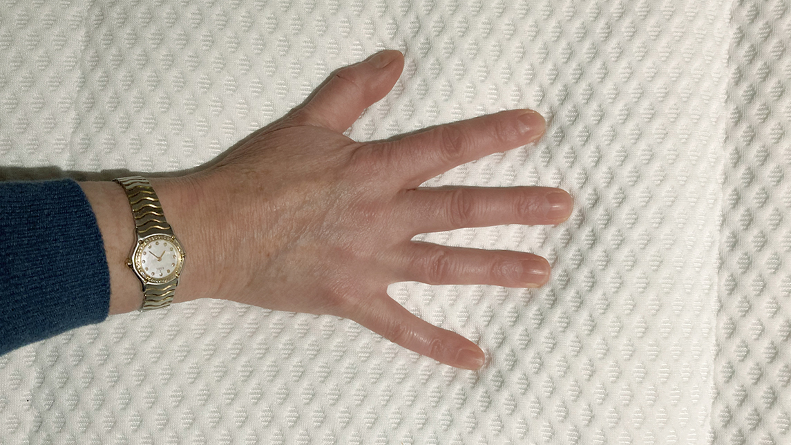 DreamCloud Luxury Hybrid mattress review: One reviewer places his hand on the top of the DreamCloud Luxury Hybrid mattres