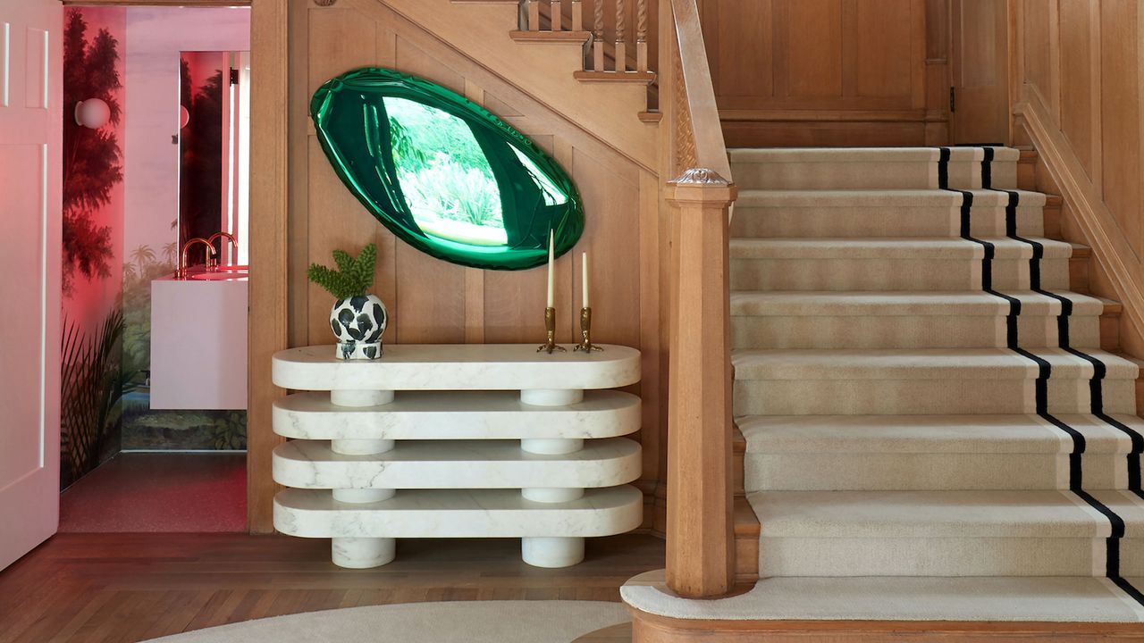 a modern console table in a wood paneled entryway