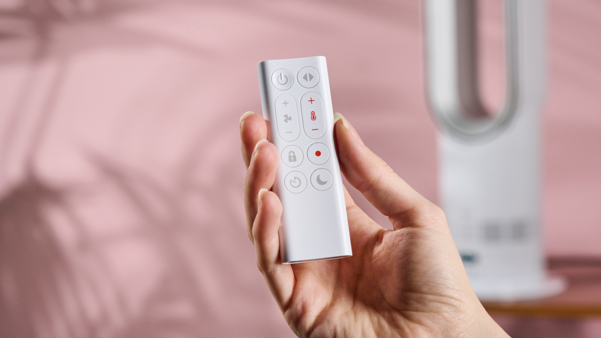 Someone is holding the remote of the Dyson Hot and Cool HF1.