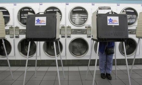 A voter casts her ballot at the Su Nueva Launderia on the southwest side of Chicago in 2008