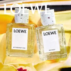 loewe ibttersweet oud iris root and roasted vanilla fragrance bottles on a yellow background