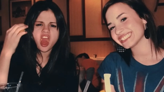 A young Selena Gomez and Demi Lovato smile at the camera in a candid shot for the Hulu doc &quot;Child Star&quot;, directed by Lovato