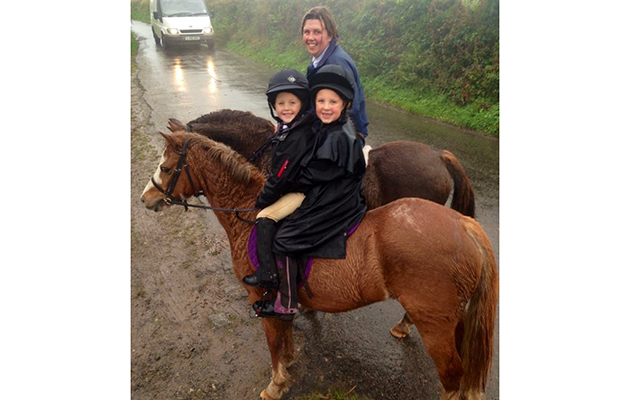 Zoe Rowe hitches a ride while her children Archie and Beth enjoyed a wet morning hunting with the Four Burrow Hunt in Cornwall recently. Photo credit Amy Jones