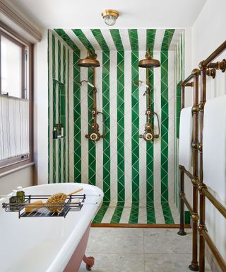 Shower room with green and white tiles and freestanding bath