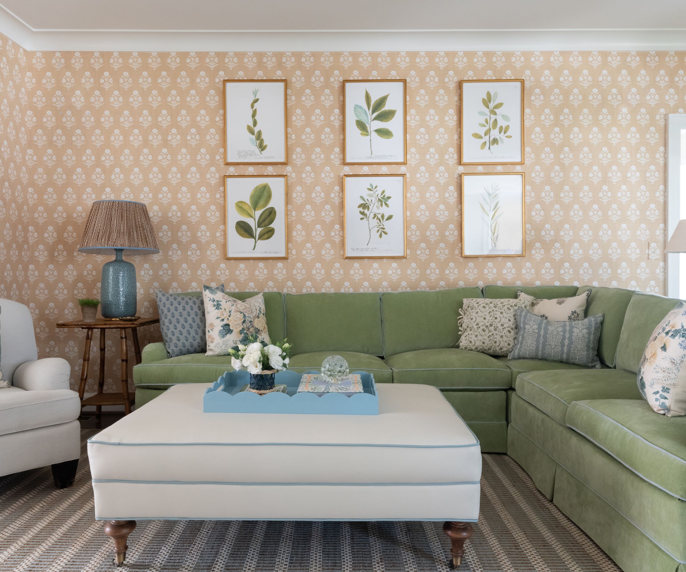 traditional living room with pistachio green corner sofa, peachy pink and white wallpaper