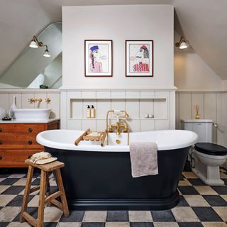 black and white bathroom floor tiles with navy freestanding bath