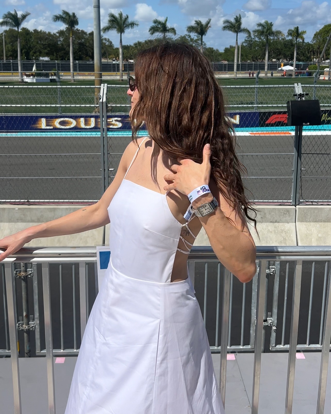 Eliza Huber at the Miami Grand Prix wearing a white Tibi sundress.